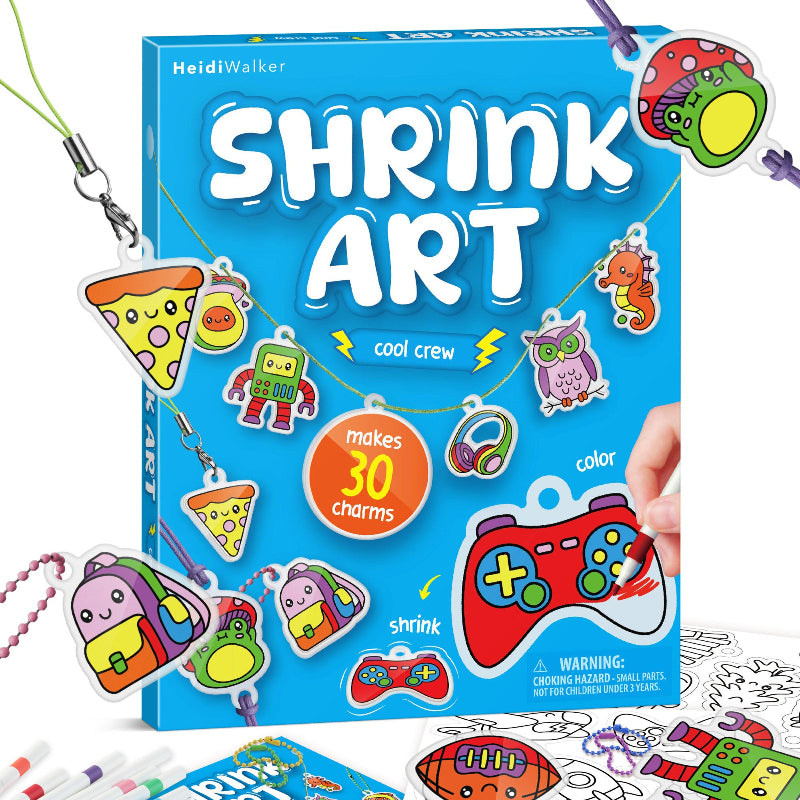 Front packaging of the HeidiWalker Shrink Art Kit ("Cool Crew" edition) showing pre-cut charms like pizza, game controllers, and animals along with colourful chains.