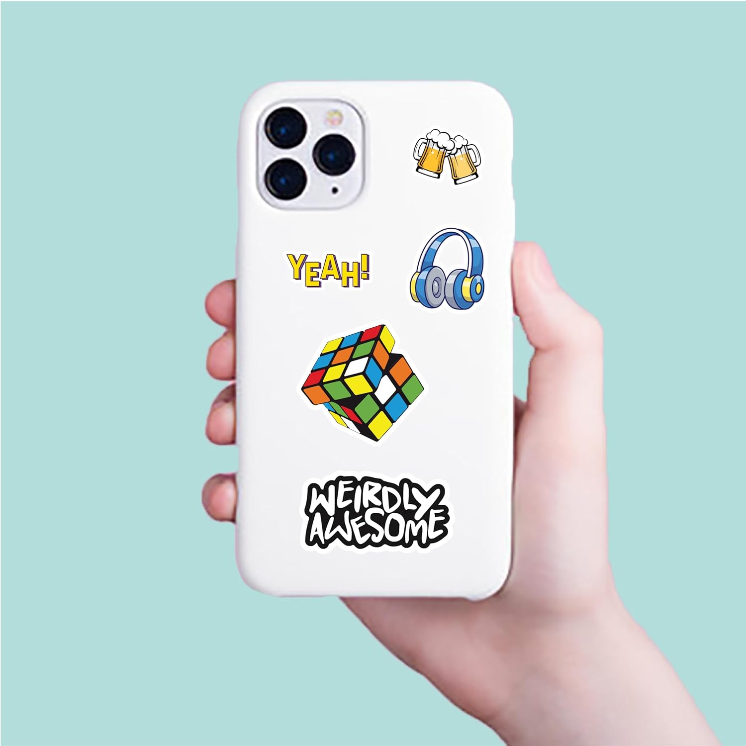 Phone case with colorful designs held by a hand against a light blue background