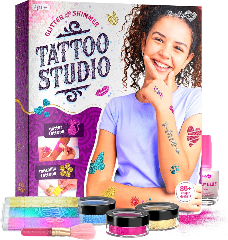 Product box for the Pretty Me Glitter and Shimmer Tattoo Studio showing a smiling girl displaying glitter tattoos on her arms, alongside product components.
