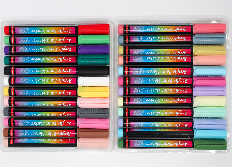 Set of colorful markers in a transparent case on a white background