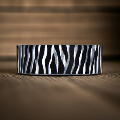 Ceramic bowl with black and white zebra pattern on a wooden surface