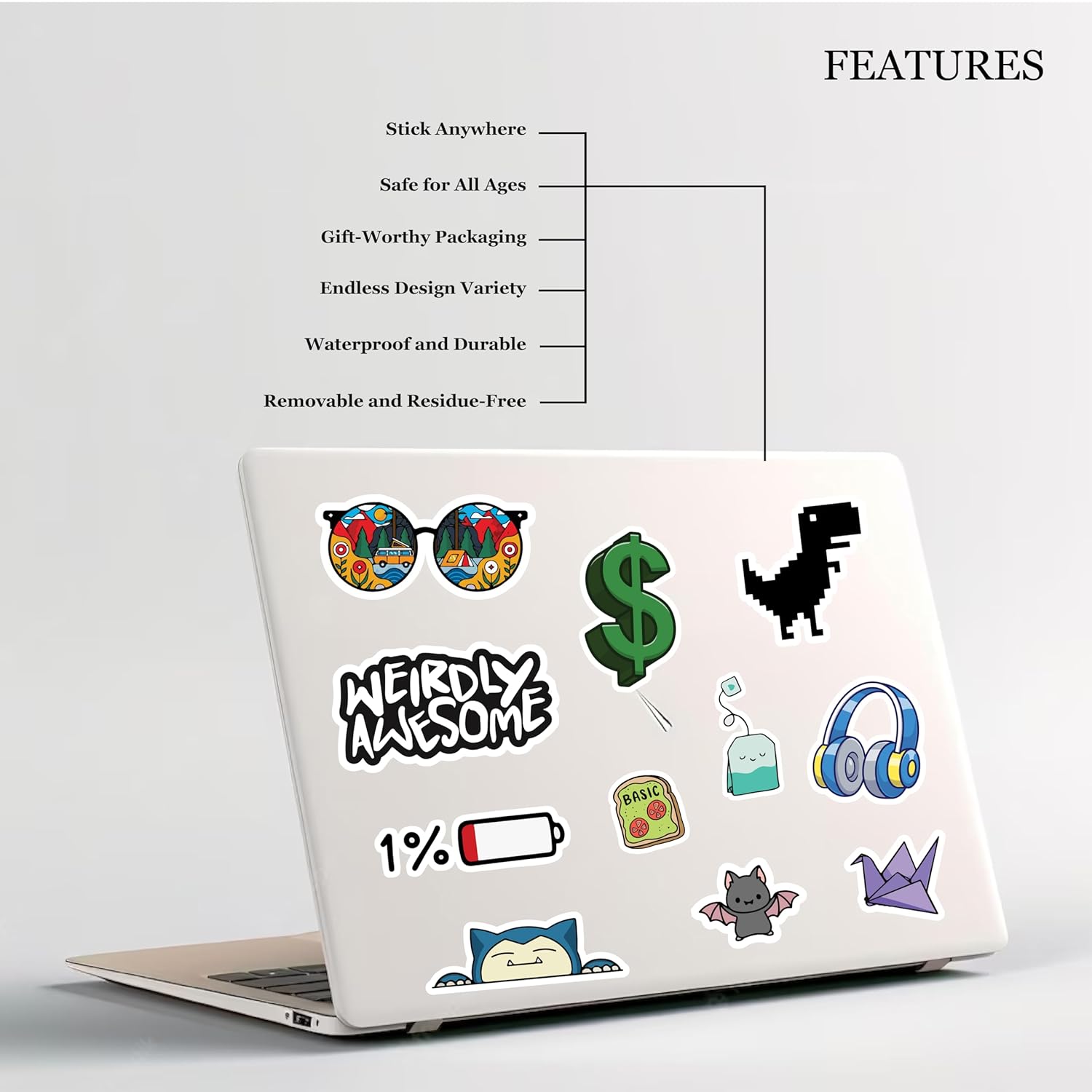 Laptop with various stickers on a light gray background, featuring text about product features.