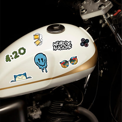 Motorcycle fuel tank with various stickers on a dark background