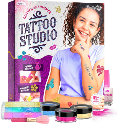 Product box for the Pretty Me Glitter and Shimmer Tattoo Studio showing a smiling girl displaying glitter tattoos on her arms, alongside product components.