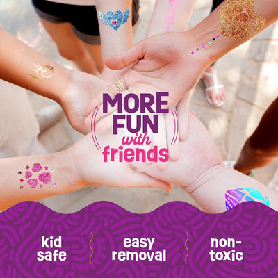 Group of children holding hands together in a circle, displaying different glitter, foil, and gem body art creations.