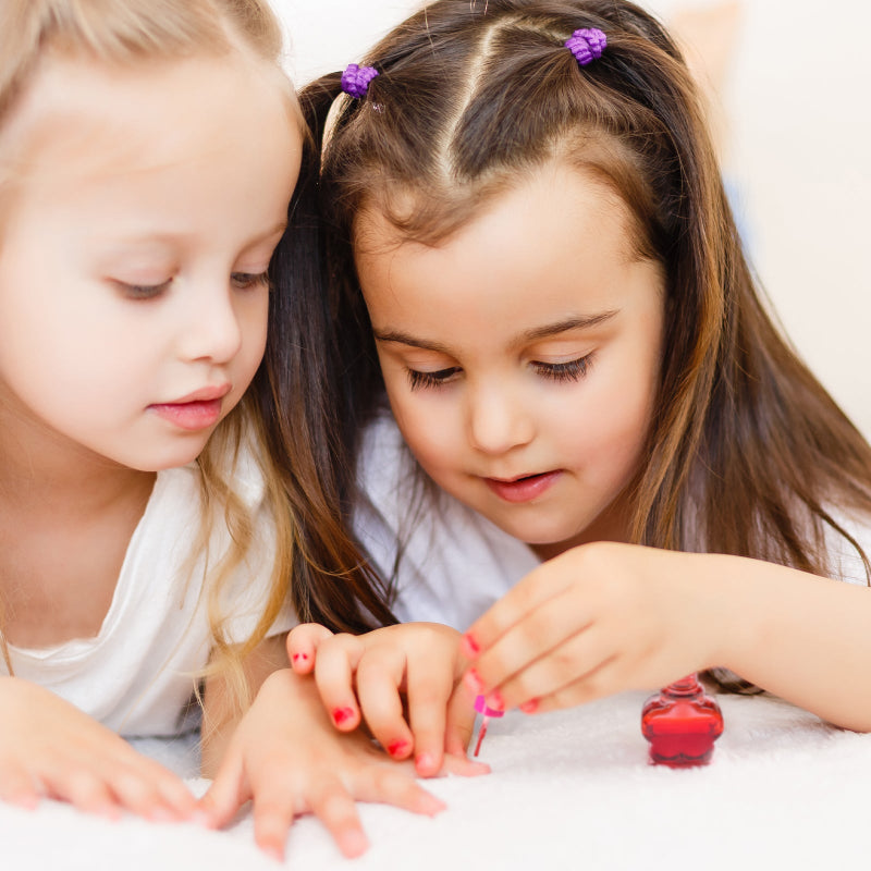 Two young girls playing with a Nail and Lip Balm DIY Kit. Buy now from DoodleVerse