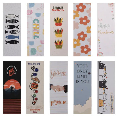 A collection of colorful paper bookmarks with various designs, including text, animals, and abstract patterns.